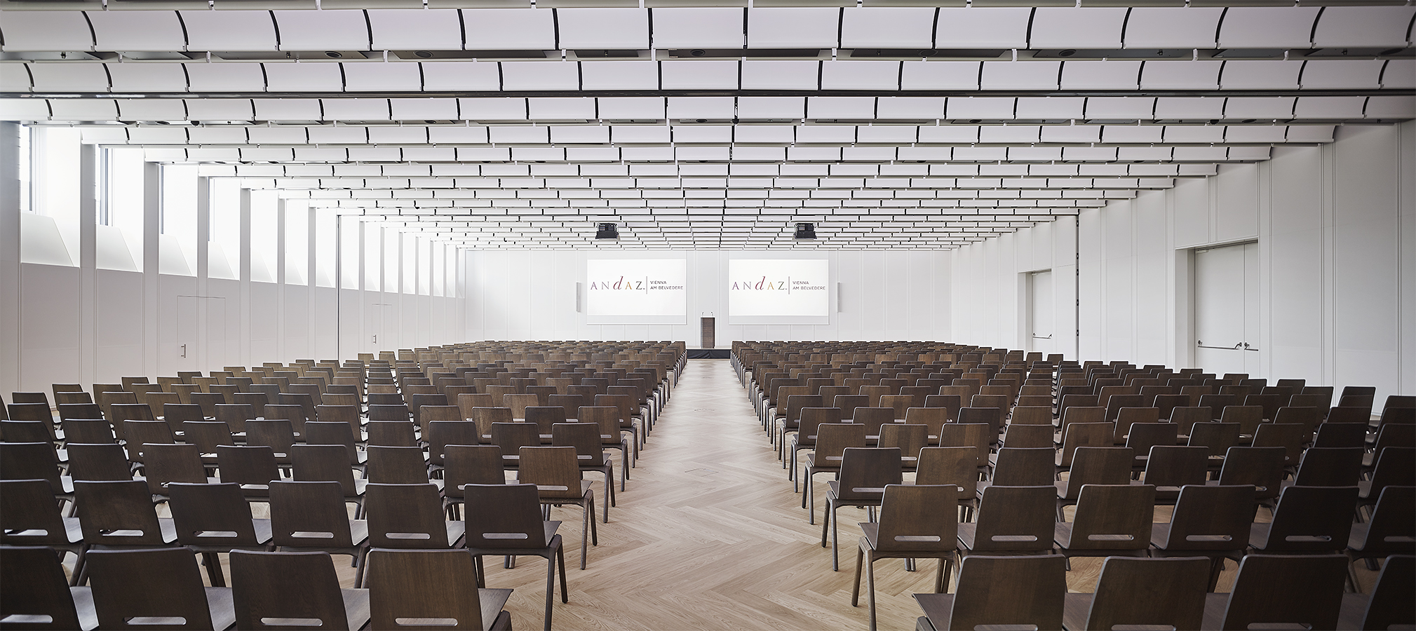 The Lower Belvedere conference room laid out in theatre style under its white slatted ceiling
